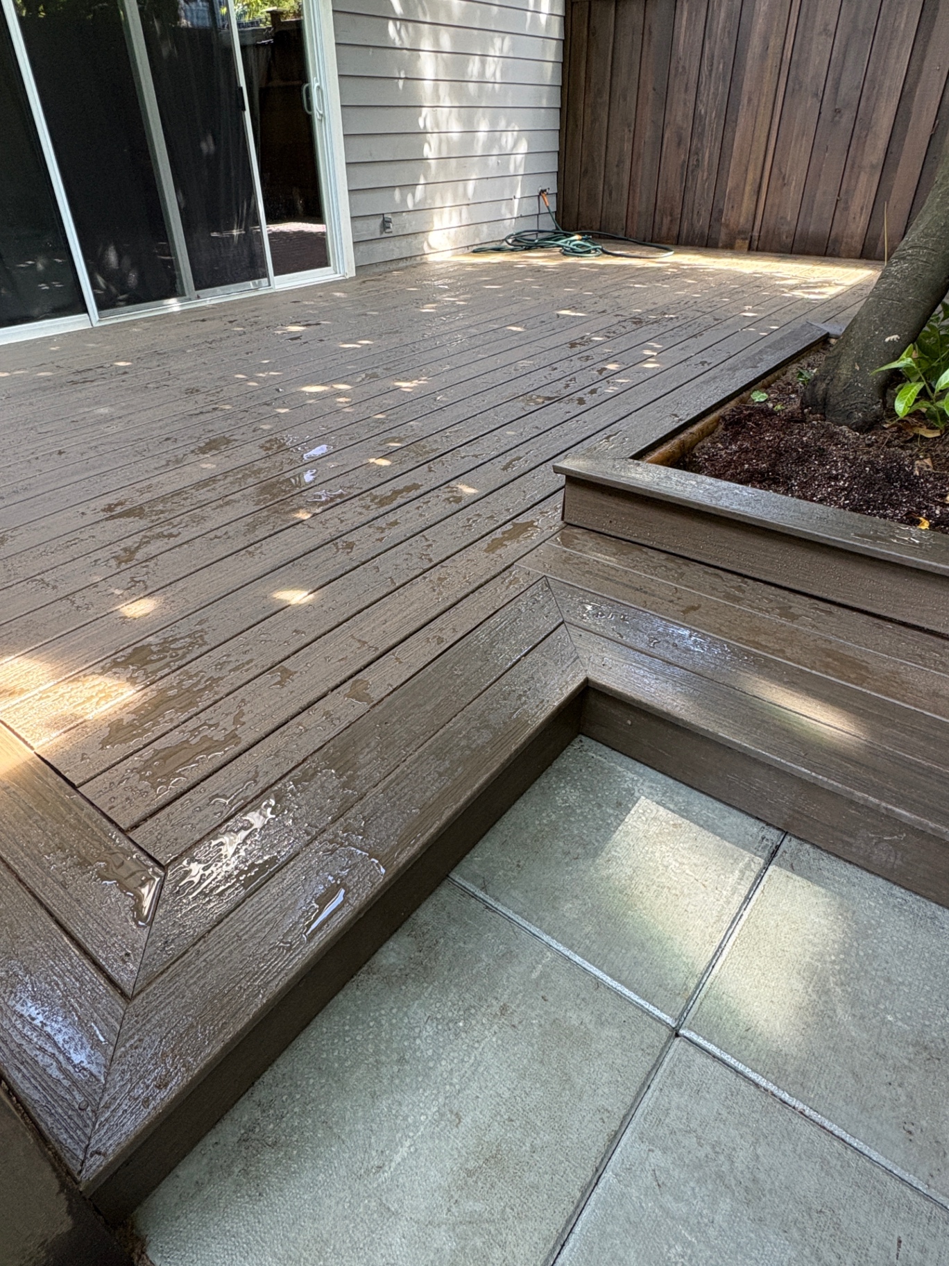 Composite deck with a built-in cedar planter box and wrap-around step